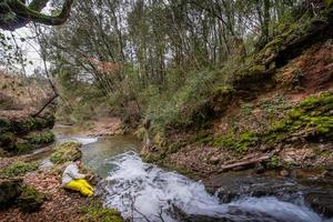 Tuscany, Italy 2021- Unknown people at the waterfall of the Bruna stream photo