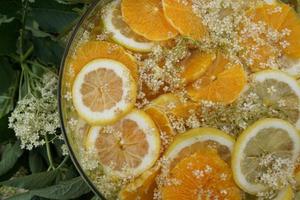 Detail Of Citrus Fruit Slice And Elderberry Juice In The Glass Bowl. photo