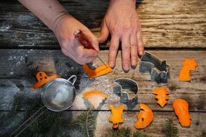 Woman Hands And Christmas Decorative Figures Made Of Orange Peel On The Old Wood Table.