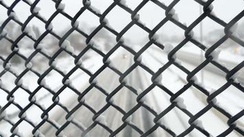 View on highway thru fence after snow storm with focusing on fence video