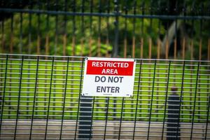 security fence border wall with do not enter sign photo