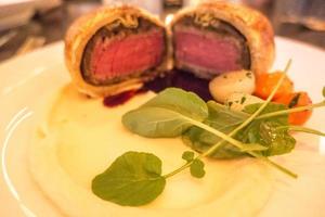 beef wellington tenderloin cooked for dinner photo