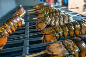 lobster tails grilled for dinner on grill photo