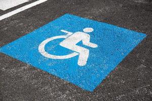 Handicapped symbol painted on asphalt. Traffic sign photo