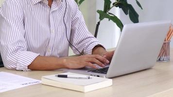 Asian businessman working with laptop in office video