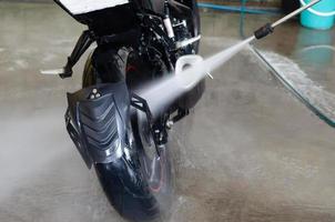 Wash the motorbike at the car wash shop photo