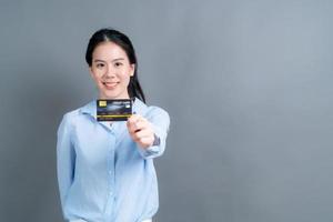 retrato, de, un, encantador, joven, mujer asiática, actuación, tarjeta de crédito foto