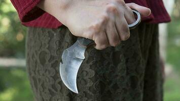 Karambit knife in lady hand tactical fighter