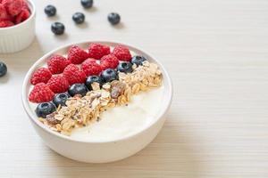 Homemade yogurt bowl with raspberry, blueberry and granola  - healthy food style photo