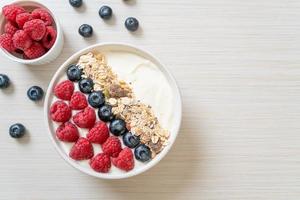 Homemade yogurt bowl with raspberry, blueberry and granola  - healthy food style photo