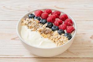 Homemade yogurt bowl with raspberry, blueberry and granola  - healthy food style photo