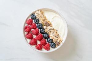 Homemade yogurt bowl with raspberry, blueberry and granola  - healthy food style photo