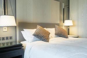 White pillows decoration on bed in bedroom interior photo