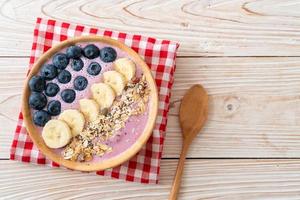 tazón de yogur o batido con arándanos, plátano y granola - estilo de comida saludable foto