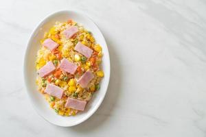 Homemade fried rice with ham and mixed vegetables of carrots and green bean peas photo