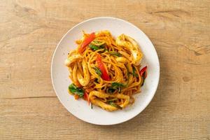 Stir-fried spaghetti with salted egg and squid - fusion food style photo