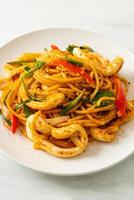 Stir-fried spaghetti with salted egg and squid - fusion food style photo