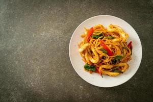 Stir-fried spaghetti with salted egg and squid - fusion food style photo