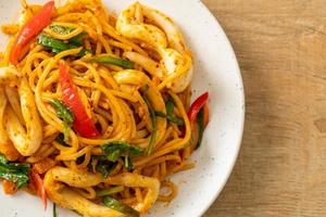 Stir-fried spaghetti with salted egg and squid - fusion food style photo