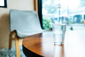 Glass of water on wood table photo