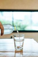 Glass of water on wood table photo