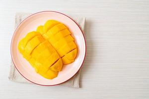 Fresh and golden mango sliced on plate photo