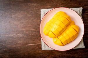 Fresh and golden mango sliced on plate photo