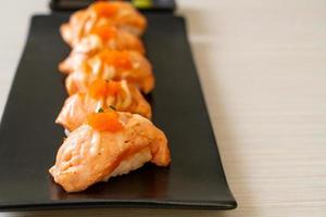 Grilled salmon sushi on black plate - Japanese food style