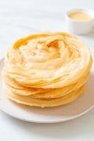 Friied crispy roti dough with sweetened condensed milk photo