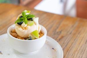 Vanilla iced-cream with fresh apple and apple crumble in cafe and restaurant photo
