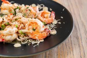 Spicy shrimp salad with herb on plate photo