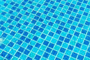 Swimming pool tiles with water surface for background photo