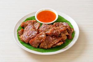 Sun-dried pork with sauce on plate photo