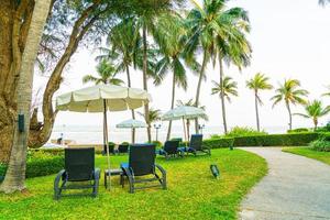 Beach chair in garden with sea background photo