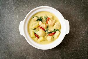 Green curry soup with minced pork and meat ball in bowl - Asian food style photo
