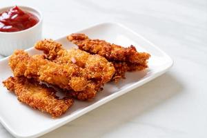 Fried chicken stick with ketchup photo