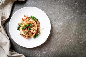 Stir-fried spaghetti with chicken and basil - fusion food style photo