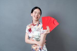 Asian woman wear Chinese traditional dress with red envelope or red packet photo