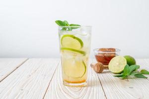 Iced honey and lime soda with mint - refreshing drink photo