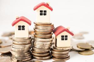 House on stack coins, mortgage home loan finance concept. photo