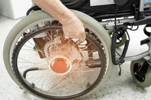 Asian senior or elderly old lady woman patient on electric wheelchair with remote control at nursing hospital ward, healthy strong medical concept photo