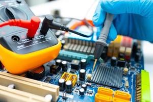 Technician repairing inside of hard disk by soldering iron. Integrated Circuit. The concept of data, hardware, technician and technology. photo