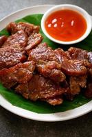 Sun-dried pork with sauce on plate photo