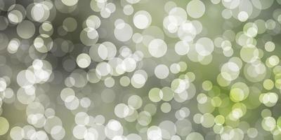 Light Green vector background with spots.