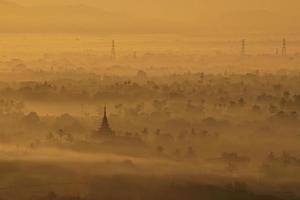 Top view of mandalay city covered with mist from mandalay hill at sunrise photo