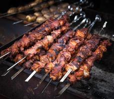 Grilling shashlik on barbecue grill photo