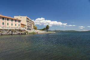 glimpse of the town of orbetello seen from the sea shore photo