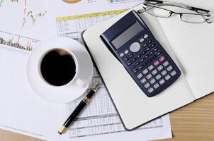 Business concept with worktable with coffee and calculator and document photo