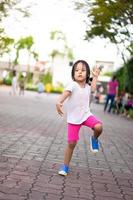 Little girl exercise by aerobic dance in the park photo