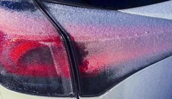 Car rear lights frosted by the cold of winter photo